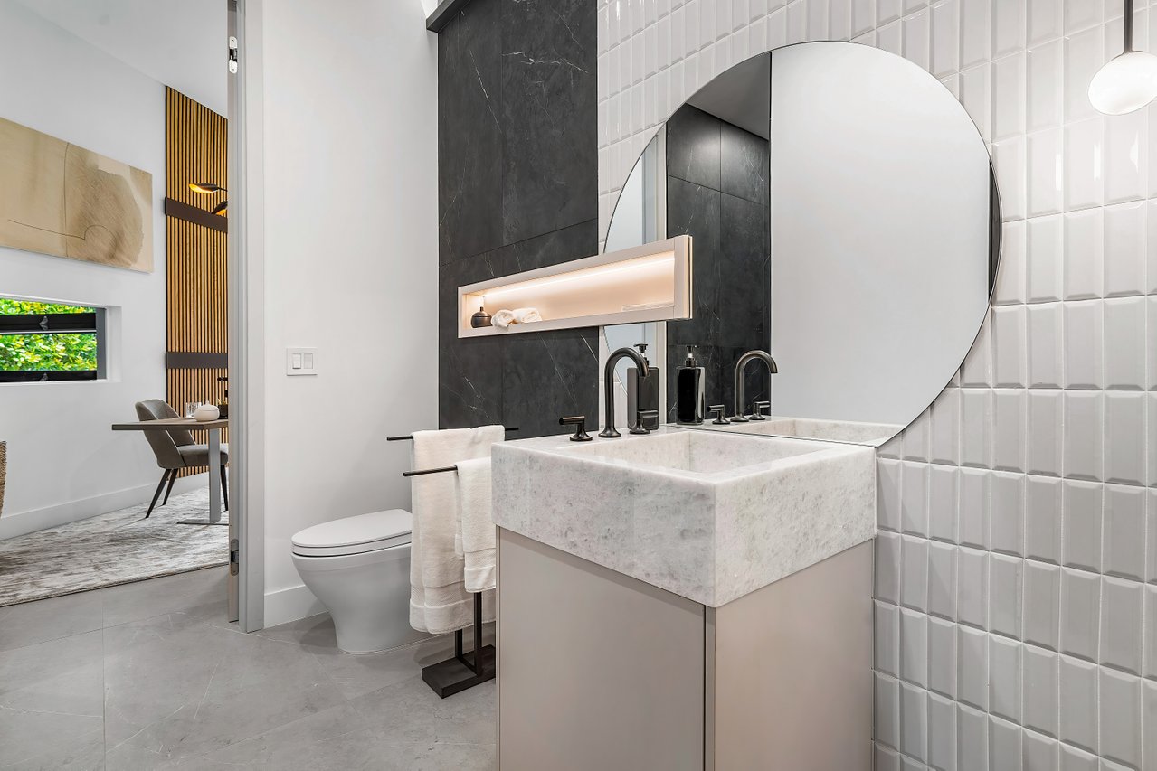 Round custom glass mirror above marble vanity by RG Glass