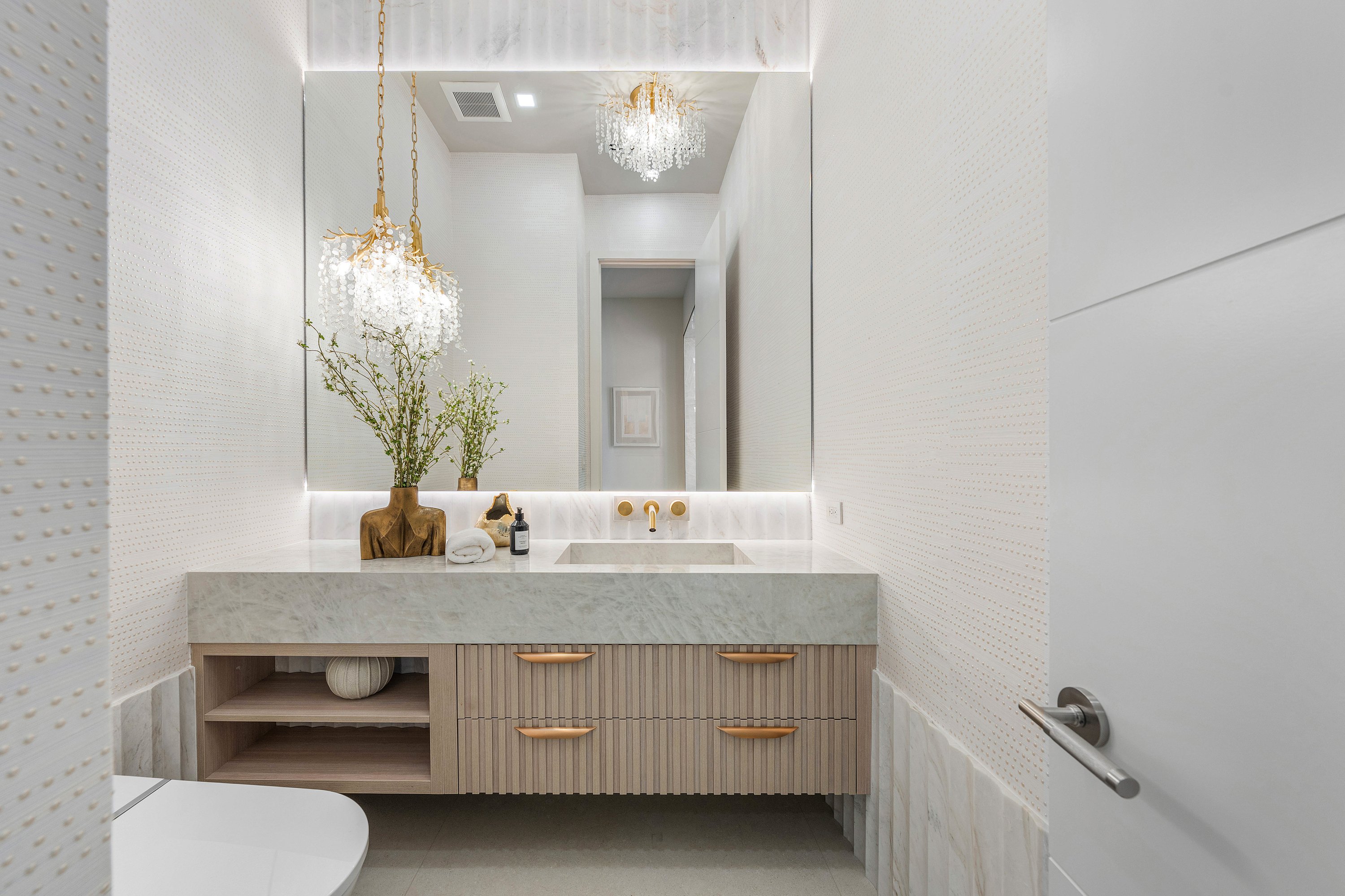 Full-wall backlit custom glass mirror by RG Glass