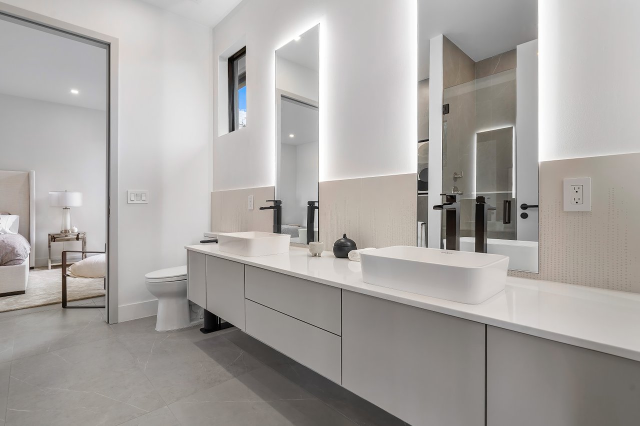 Dual backlit custom glass mirrors above vanity by RG Glass