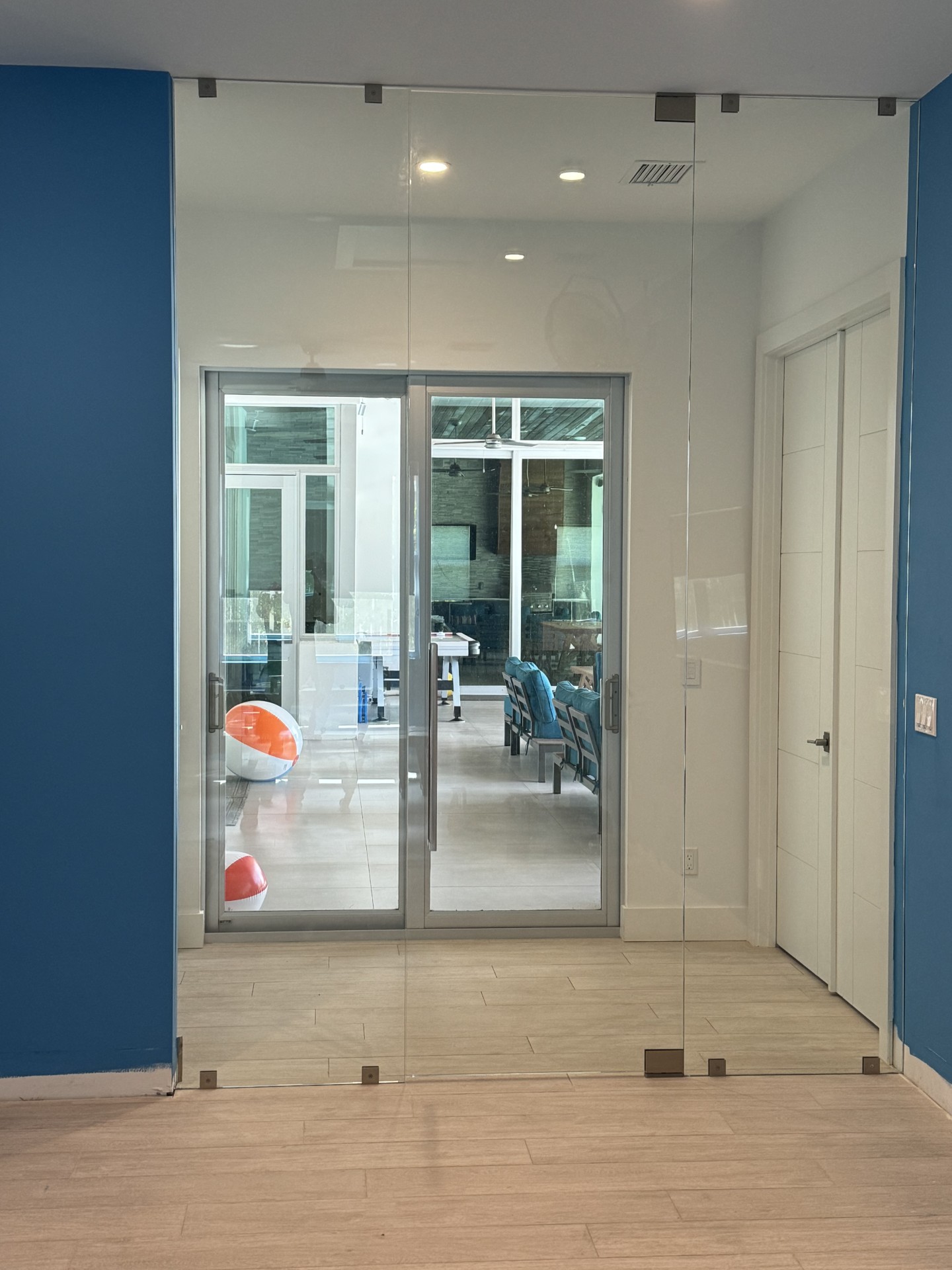Floor-to-ceiling frameless glass entry doors by RG Glass