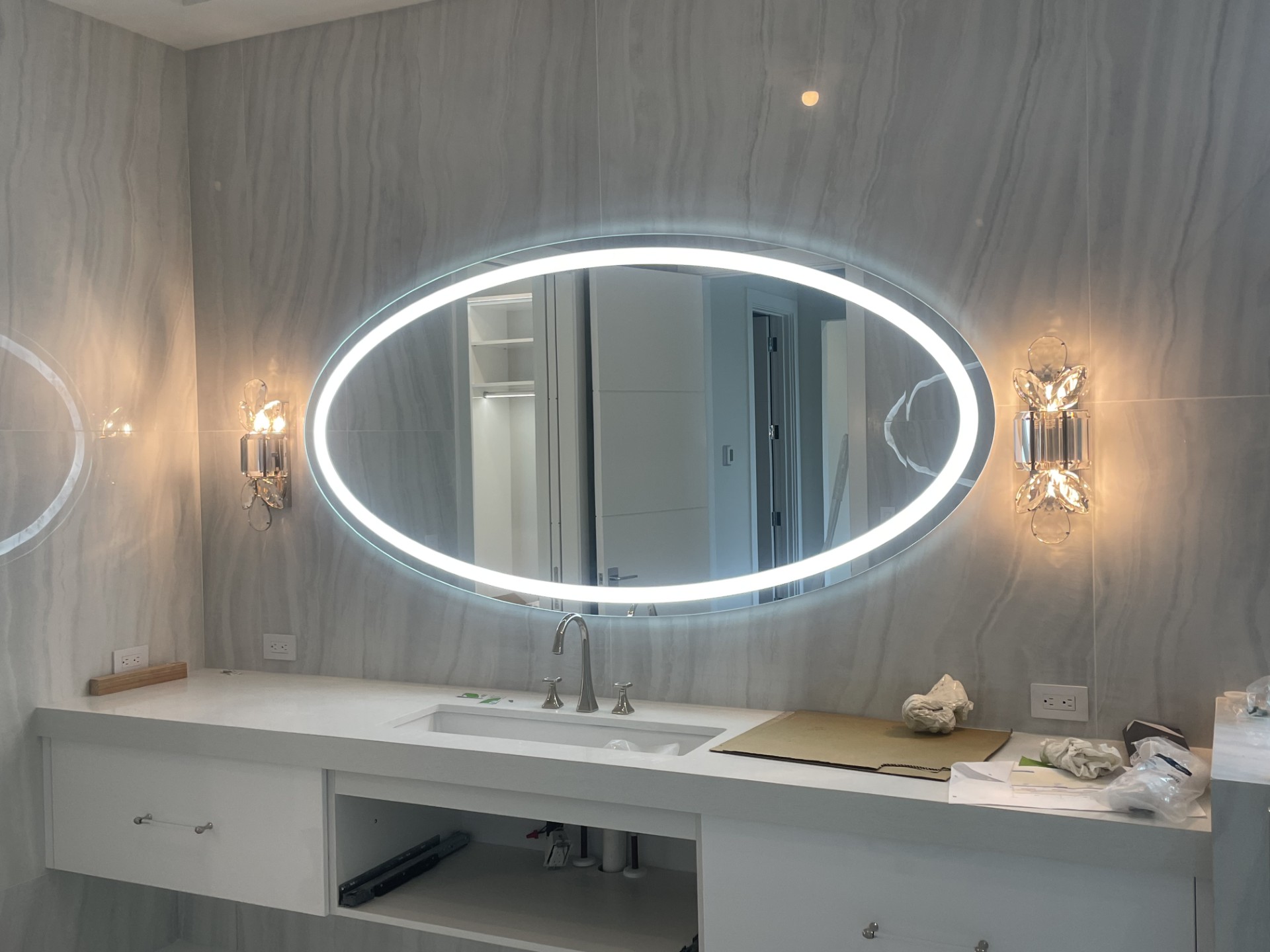 Oval backlit custom mirror installation by RG Glass