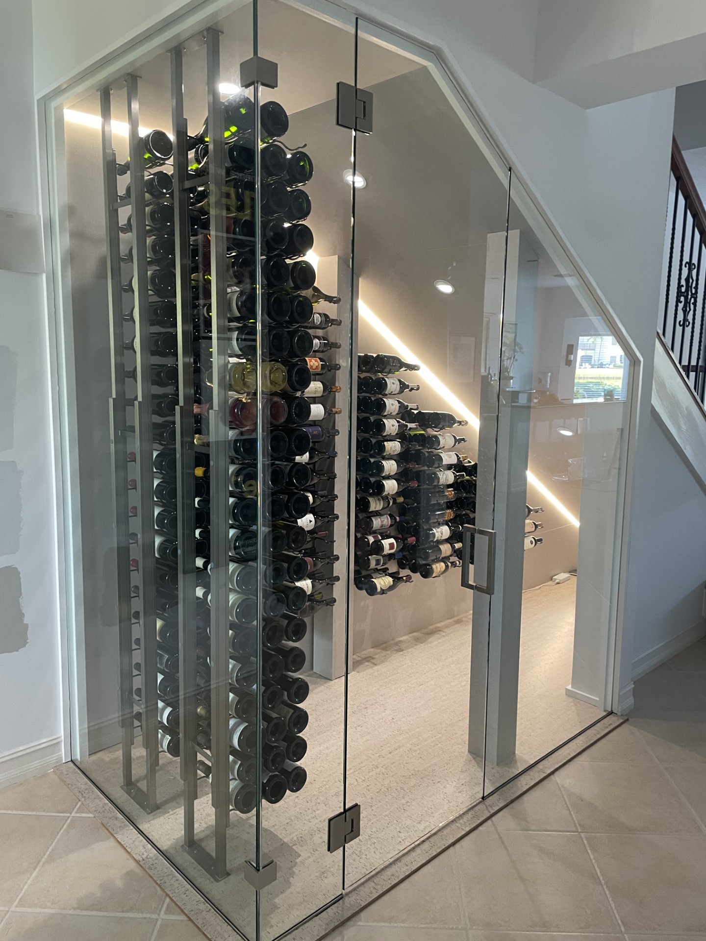 Glass-enclosed wine room and bottle display by RG Glass