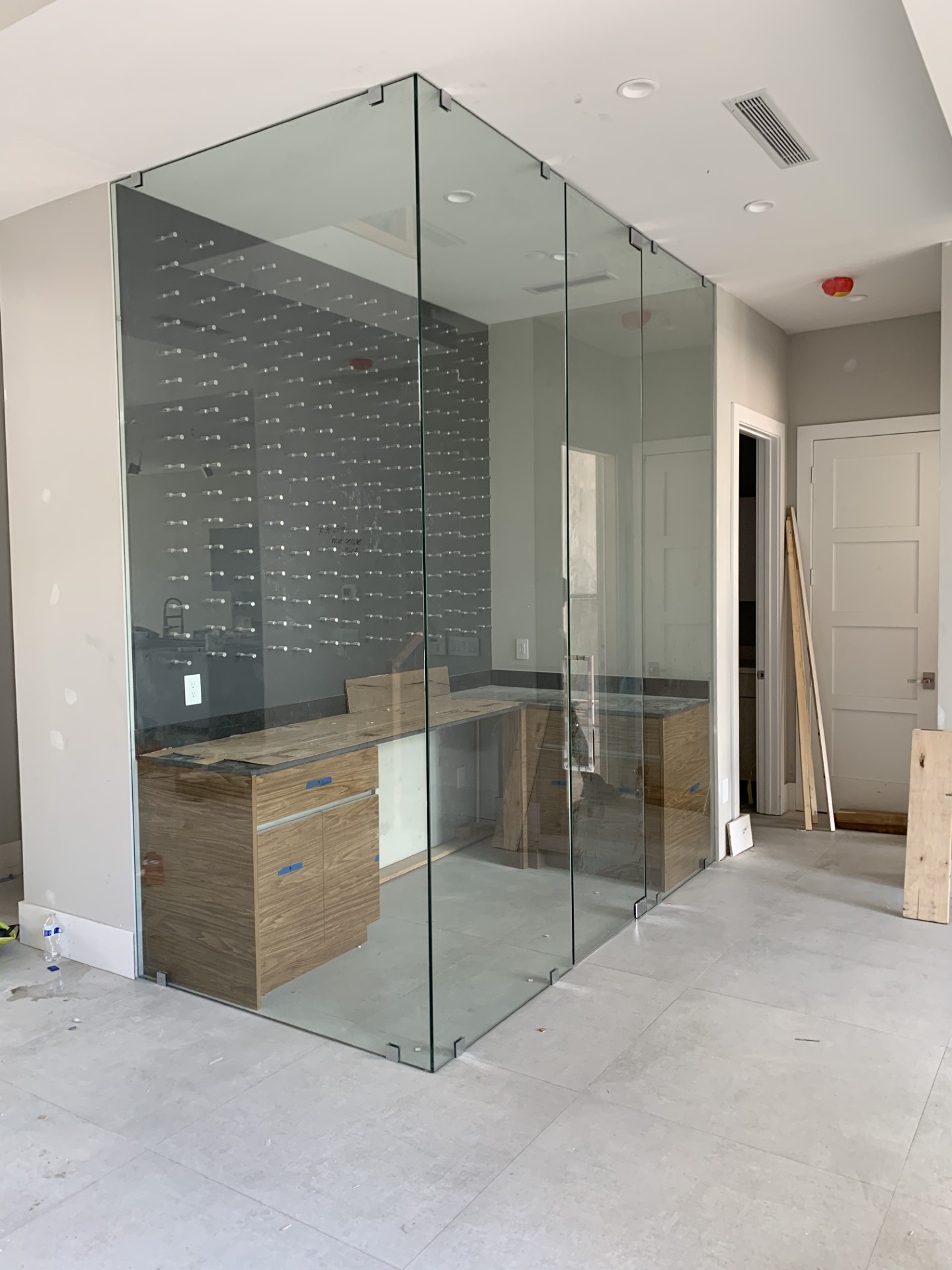 Glass-enclosed wine room display by RG Glass