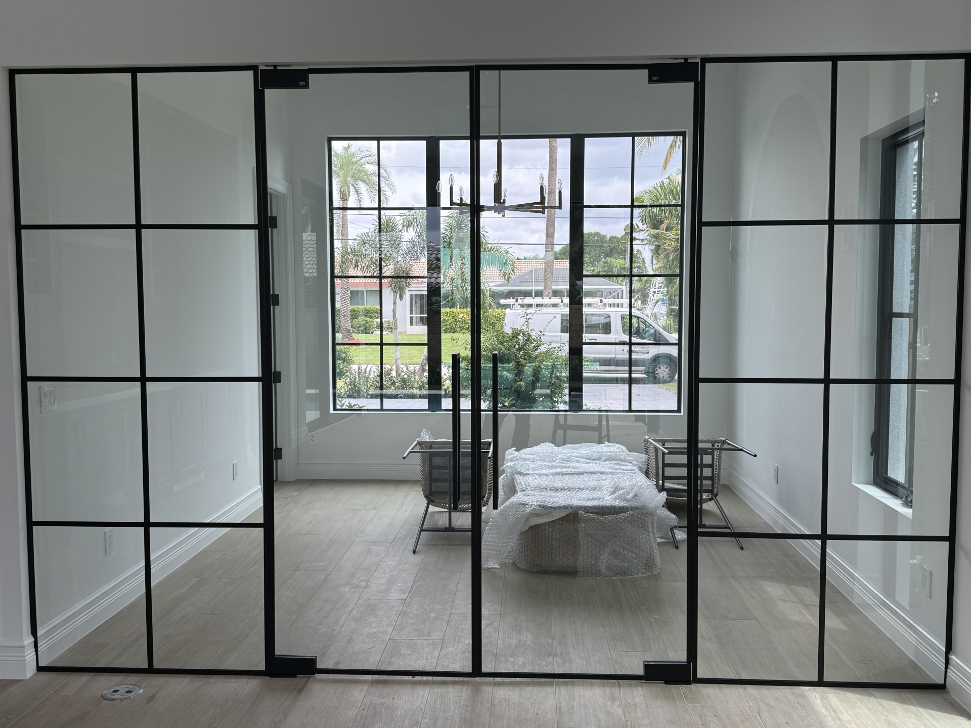 Wide grid-style interior glass partition by RG Glass