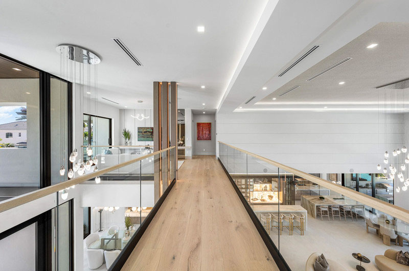Interior glass railing overlooking an open living space by RG Glass